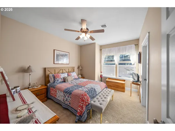 a bedroom with a bed lamps and window