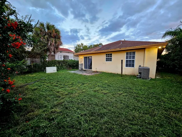 a view of a house with yard and a garden