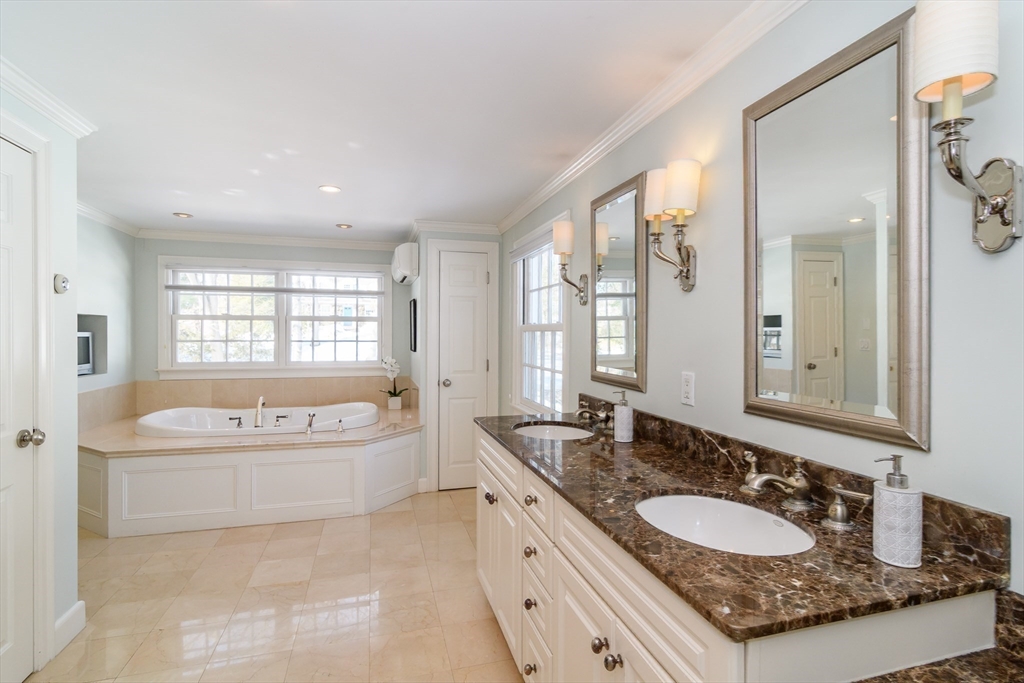 81 Audubon Road Wellesley, MA 02481 - Photo 16 of 25 a spacious bathroom with a granite countertop tub sink and mirror