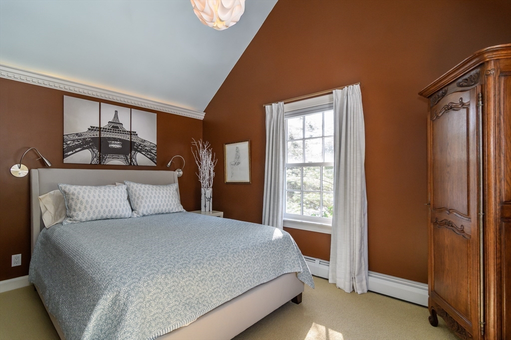 81 Audubon Road Wellesley, MA 02481 - Photo 20 of 25 a large bed sitting in a bedroom next to a window
