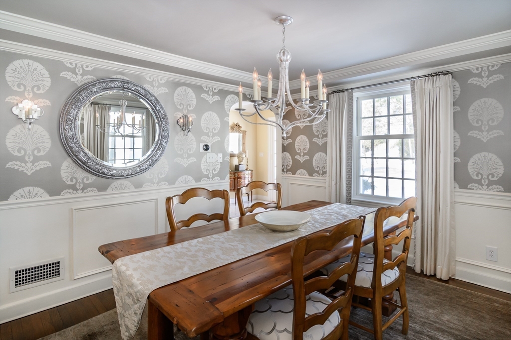 81 Audubon Road Wellesley, MA 02481 - Photo 7 of 25 a dining room with furniture a chandelier and wooden floor