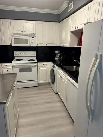 a kitchen with a refrigerator and a stove
