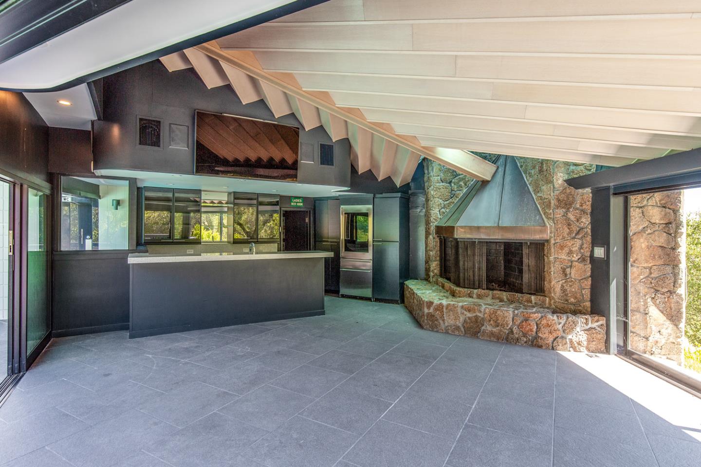 835 La Honda Road Woodside, CA 94062 - Photo 18 of 26 an empty room with a fireplace and outdoor view