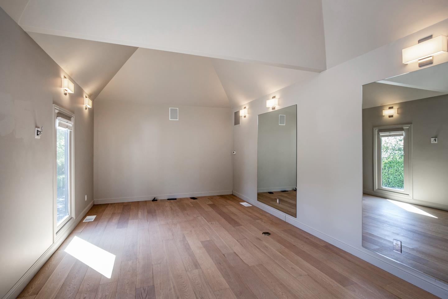 835 La Honda Road Woodside, CA 94062 - Photo 20 of 26 an empty room with wooden floor and windows
