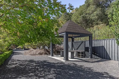 a backyard of a house with table and chairs