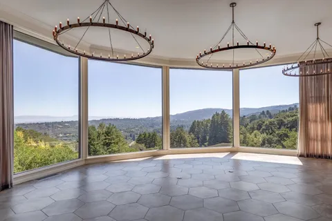 a view of a room with a large windows and table