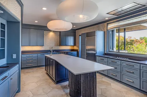 a kitchen with stainless steel appliances granite countertop a sink and a stove