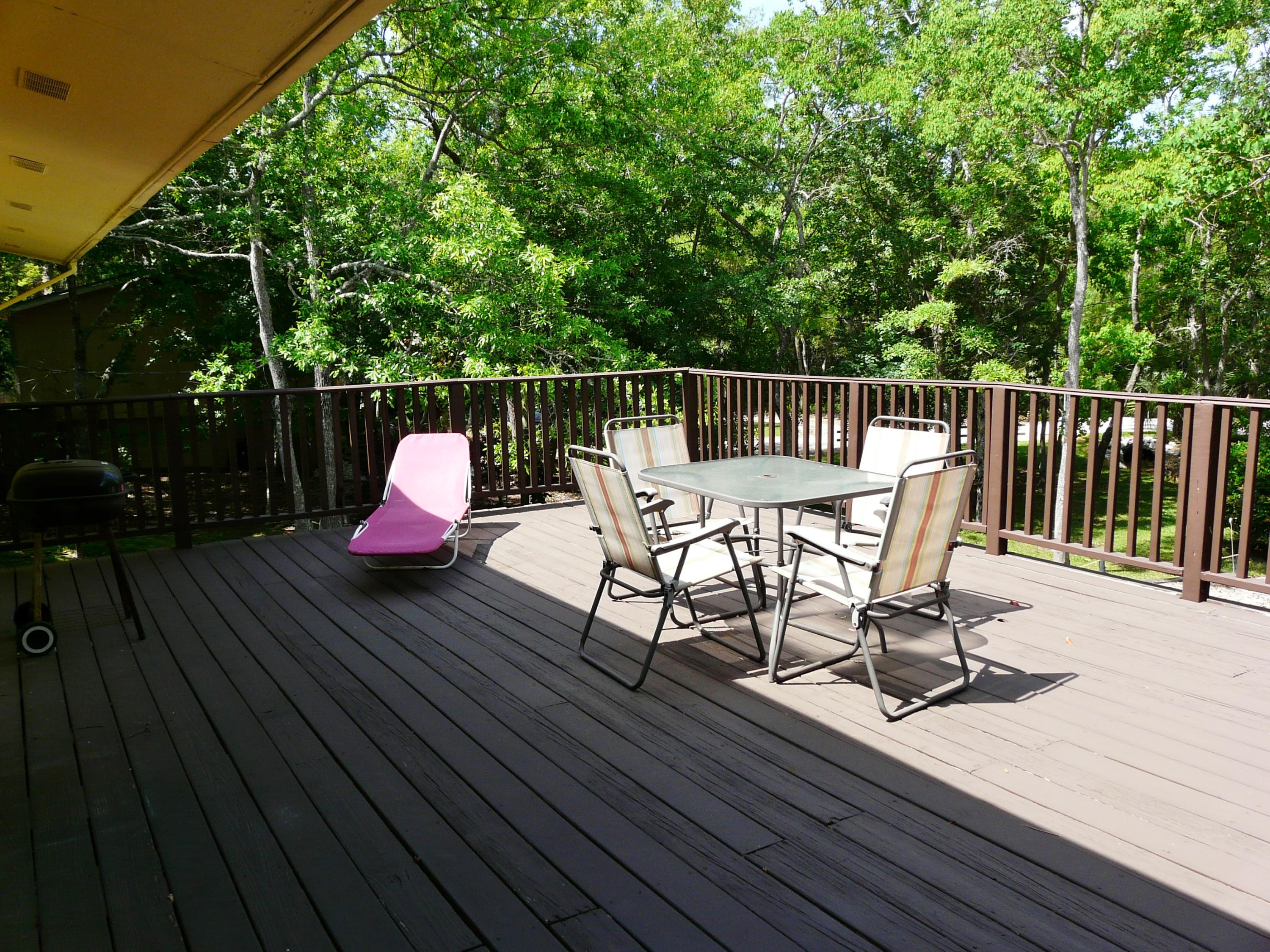 14 6th Street Shalimar, FL 32579 - Photo 15 of 23 a view of a chairs and table on the wooden deck