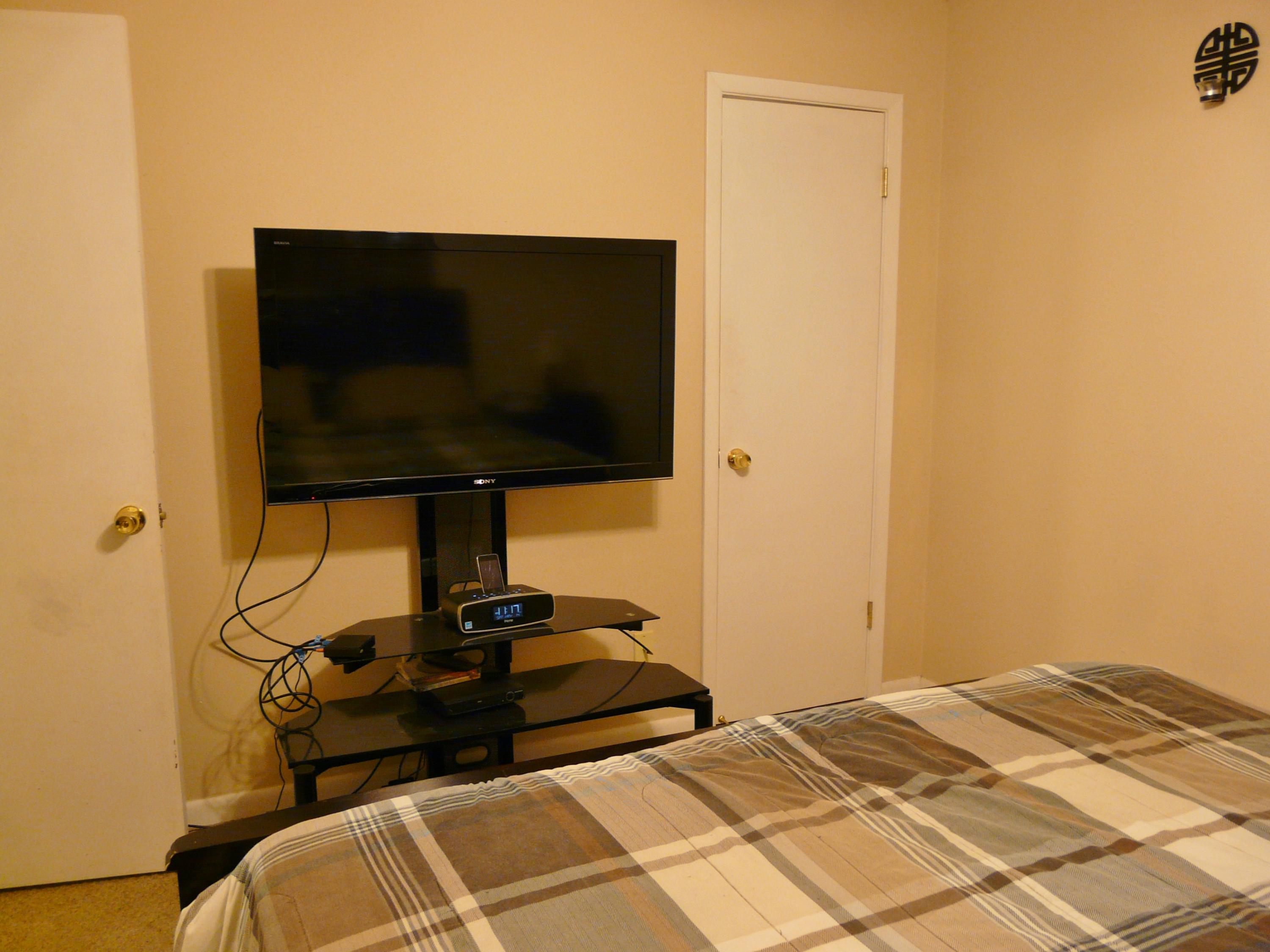 14 6th Street Shalimar, FL 32579 - Photo 21 of 23 a bedroom with a bed and a flat screen tv