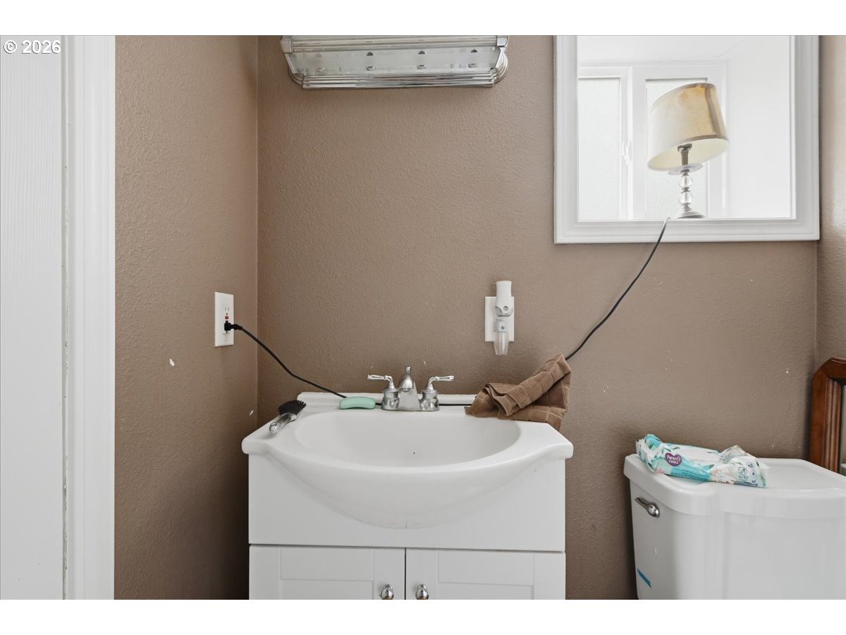 3287 Olive Way Longview, WA 98632 - Photo 12 of 24 a bathroom with a sink and a mirror