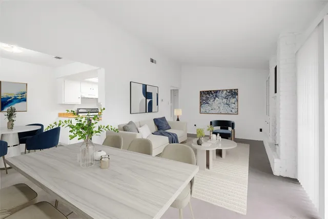 a living room with furniture potted plant and wooden floor