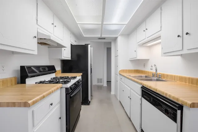 a kitchen that has a sink and a stove