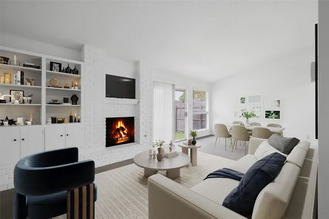 a living room with furniture a fireplace and a flat screen tv