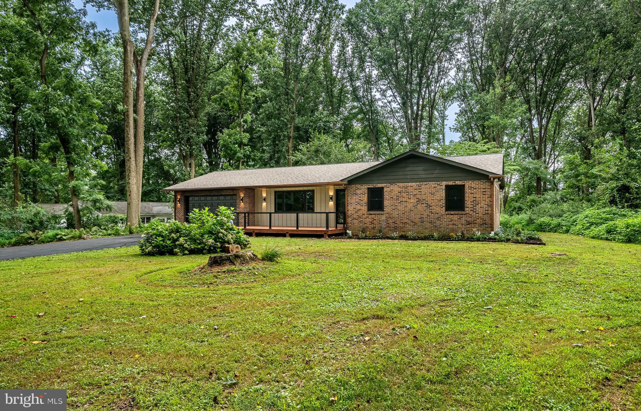 129 Chambers Road Toughkenamon, PA 19374 - Photo 3 of 60 a front view of a house with a yard and trees