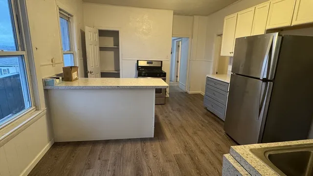 a kitchen with stainless steel appliances a refrigerator and a sink