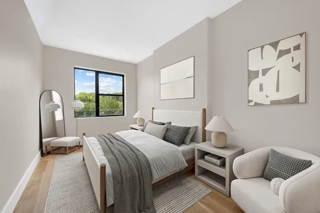 a bedroom with a bed couch and window