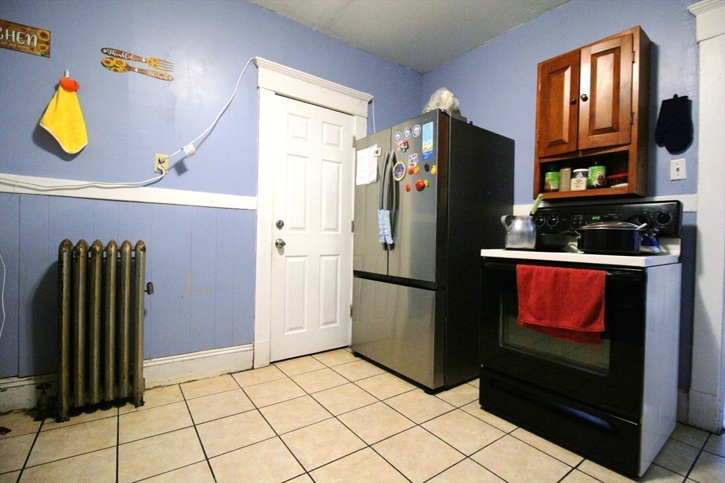 61 Kimberly Avenue Springfield, MA 01108 - Photo 12 of 39 a kitchen with a refrigerator and a stove top oven