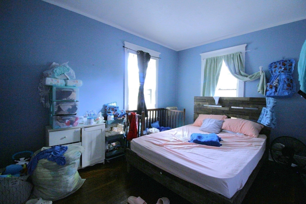 61 Kimberly Avenue Springfield, MA 01108 - Photo 15 of 39 a bedroom with a bed and wooden floor