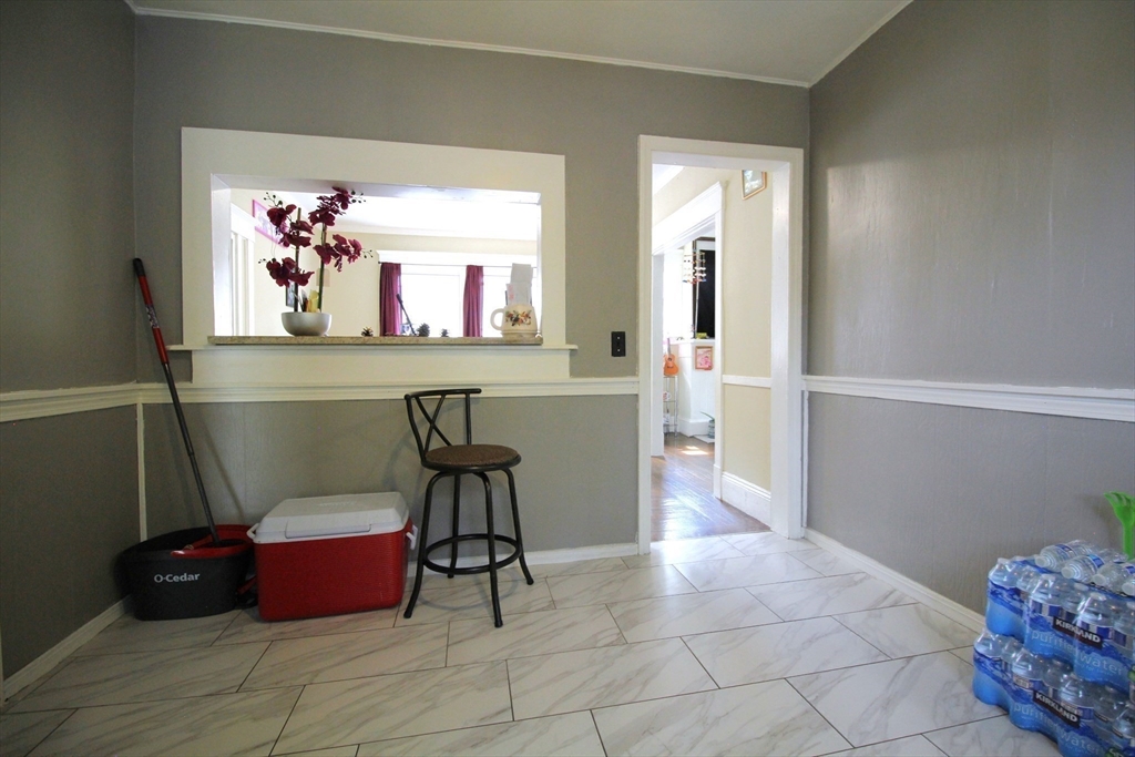 61 Kimberly Avenue Springfield, MA 01108 - Photo 23 of 39 a view of a hallway with cabinet and a potted plant