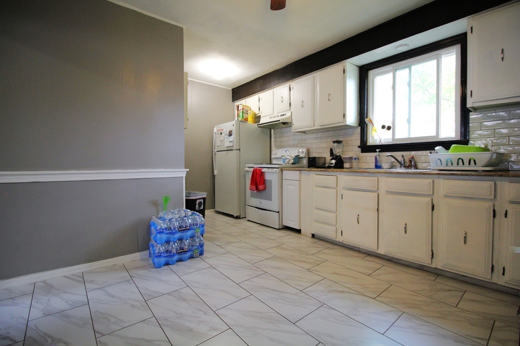 61 Kimberly Avenue Springfield, MA 01108 - Photo 24 of 39 a kitchen with granite countertop a sink cabinets and window