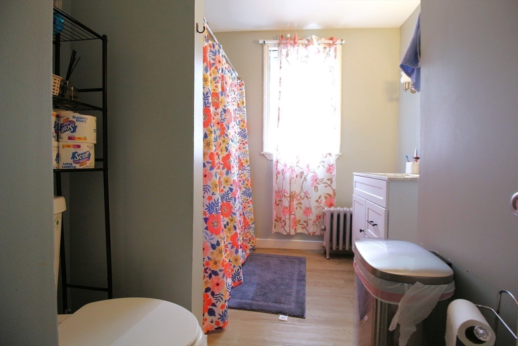 61 Kimberly Avenue Springfield, MA 01108 - Photo 26 of 39 a white toilet sitting next to a shower curtain
