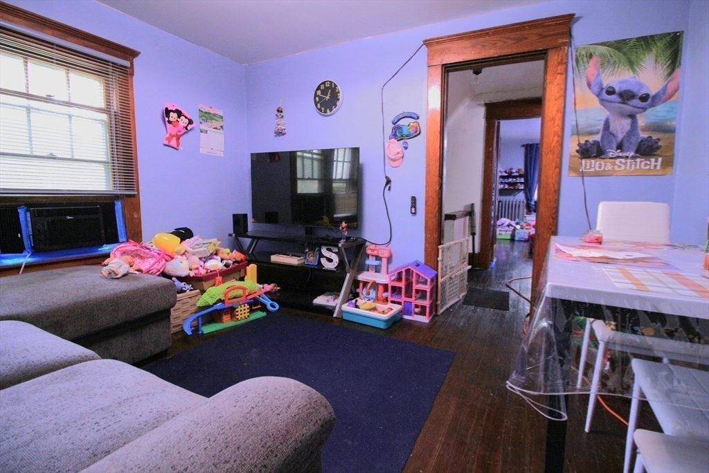 61 Kimberly Avenue Springfield, MA 01108 - Photo 30 of 39 a bedroom with furniture and a flat screen tv
