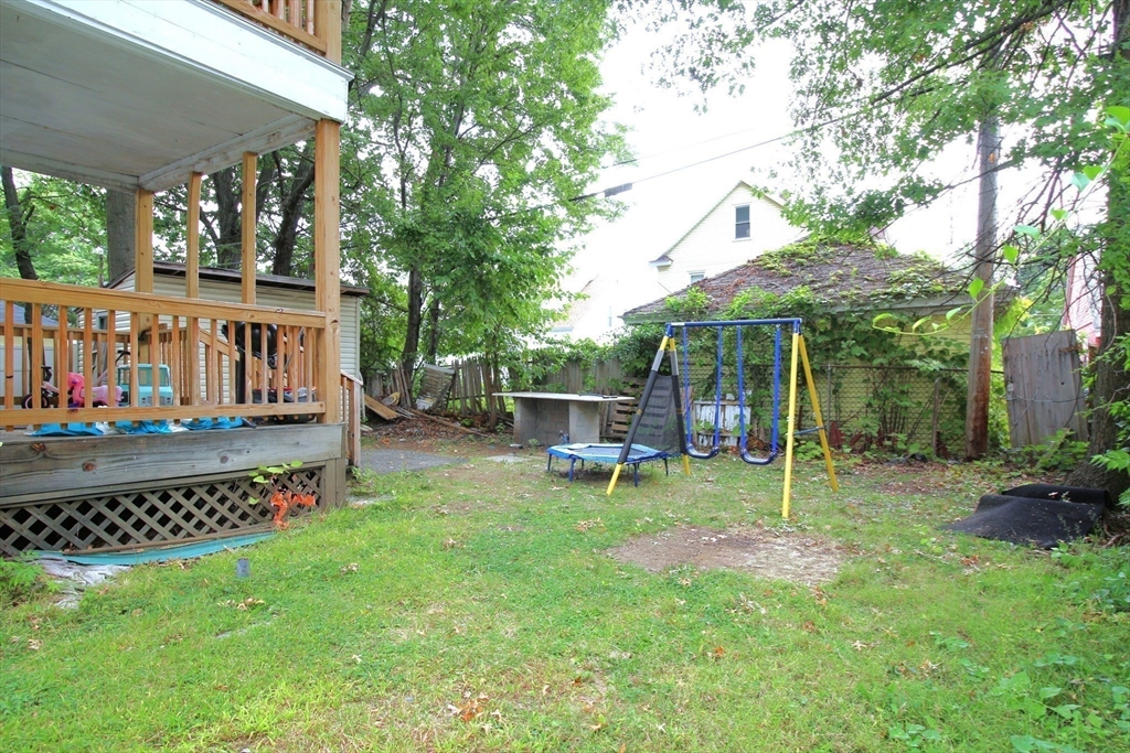 61 Kimberly Avenue Springfield, MA 01108 - Photo 5 of 39 a view of a chair and table in backyard of the house