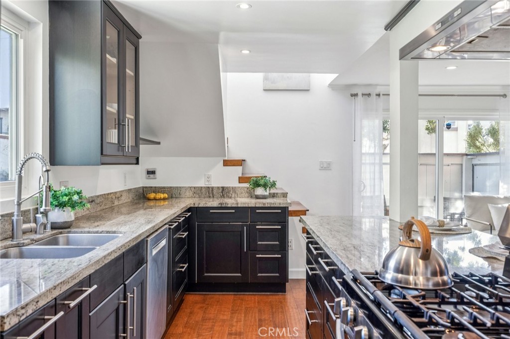 2015 Bataan Road, Unit 102 Redondo Beach, CA 90278 - Photo 11 of 43 a kitchen with a sink stove and cabinets