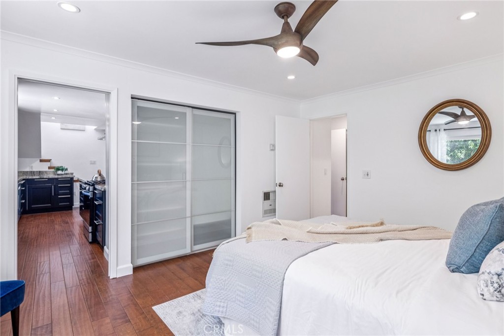 2015 Bataan Road, Unit 102 Redondo Beach, CA 90278 - Photo 17 of 43 a bedroom with a bed and a chandelier