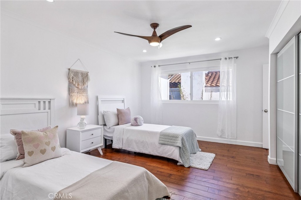 2015 Bataan Road, Unit 102 Redondo Beach, CA 90278 - Photo 31 of 43 a bedroom with two beds and a ceiling fan
