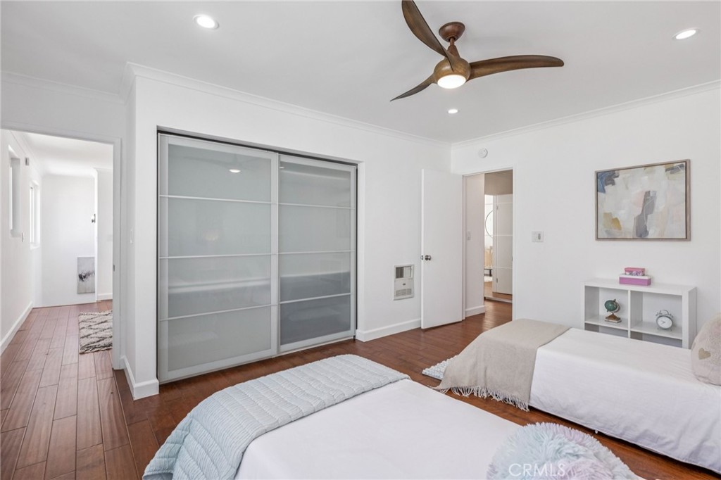 2015 Bataan Road, Unit 102 Redondo Beach, CA 90278 - Photo 32 of 43 a bedroom with a bed and a chandelier