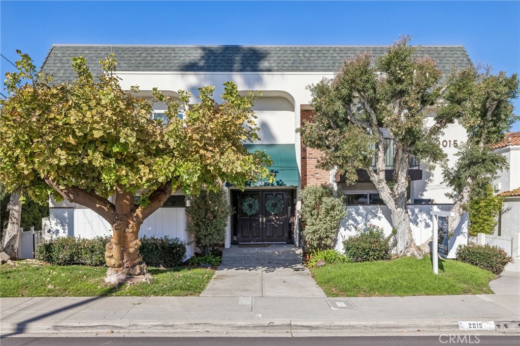 2015 Bataan Road, Unit 102 Redondo Beach, CA 90278 - Photo 40 of 43 a front view of a house with a yard and garage