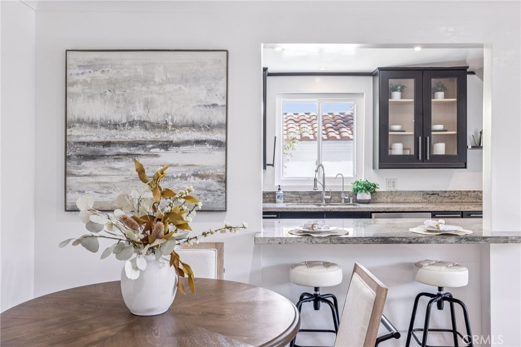 2015 Bataan Road, Unit 102 Redondo Beach, CA 90278 - Photo 6 of 43 a dining room with table chairs and wooden floor