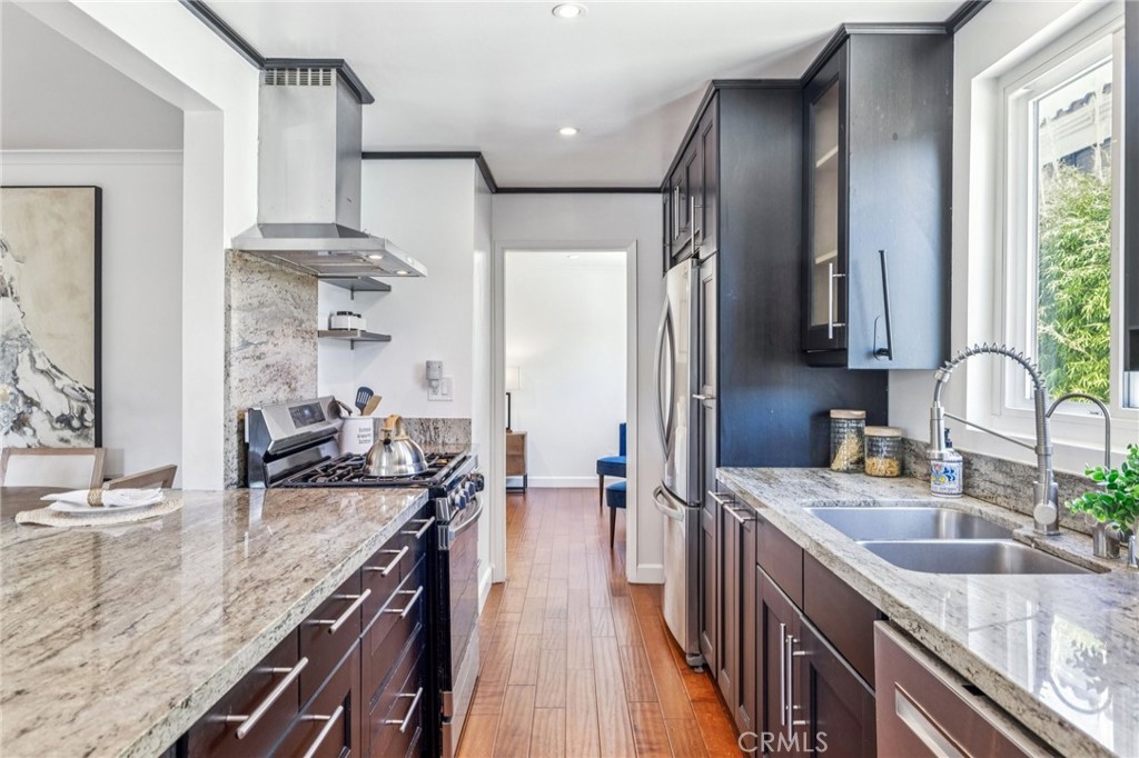 2015 Bataan Road, Unit 102 Redondo Beach, CA 90278 - Photo 10 of 43 a kitchen with stainless steel appliances granite countertop a sink stove and refrigerator