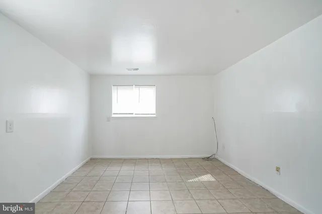an empty room with a empty space and windows