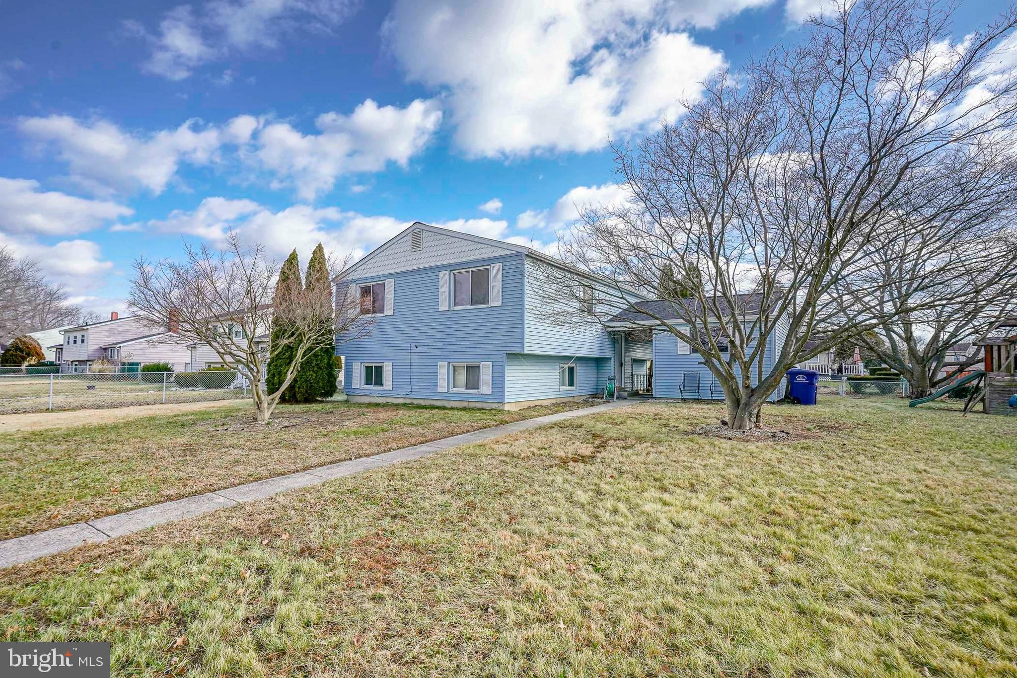 220 College Drive Pemberton, NJ 08068 - Photo 2 of 28 a brick house next to a yard with large trees