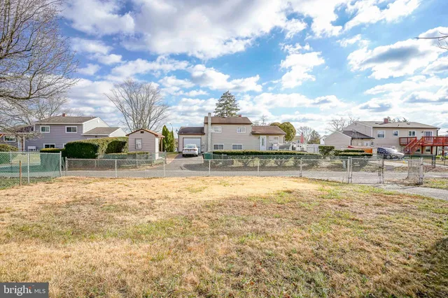 a swimming pool with outdoor seating and yard