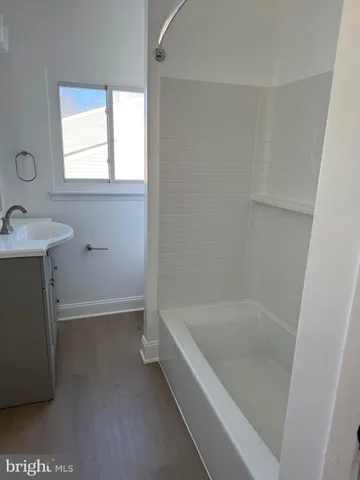a white bath tub sitting next to a white sink