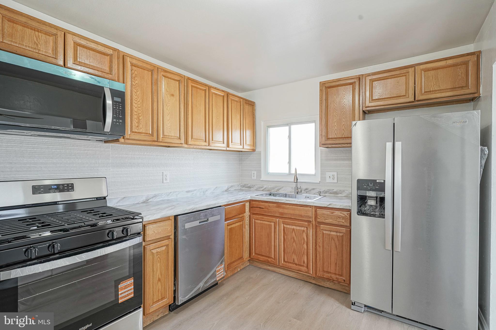 220 College Drive Pemberton, NJ 08068 - Photo 8 of 28 a kitchen with stainless steel appliances granite countertop a stove microwave refrigerator and sink