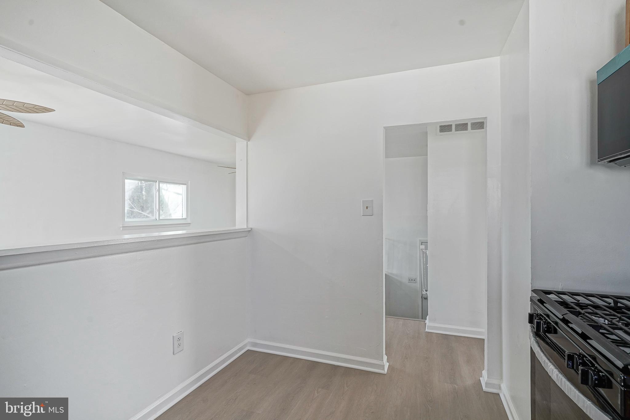 220 College Drive Pemberton, NJ 08068 - Photo 9 of 28 a view of a kitchen with white cabinets and wooden floor