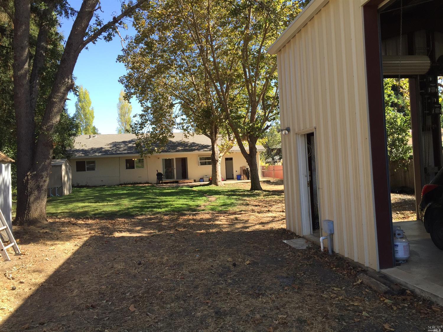 The house seen from the accessory building, gravel drive.