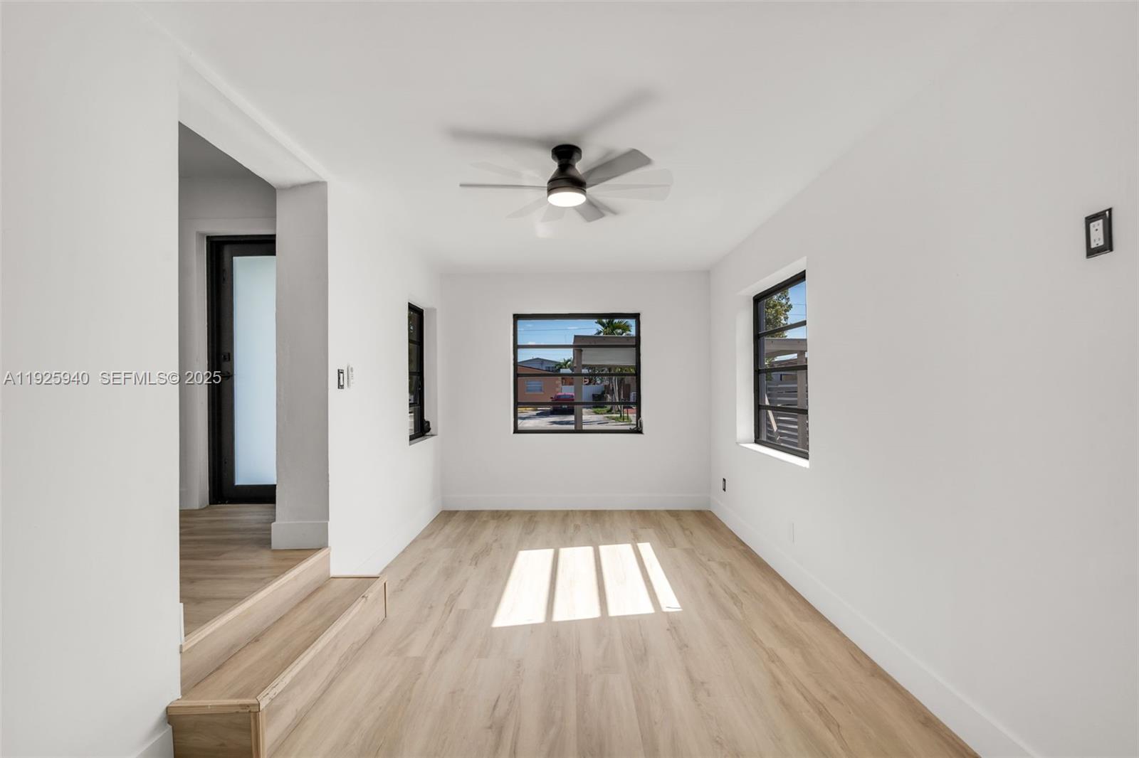739 West 30th Street Hialeah, FL 33012 - Photo 14 of 23 wooden floor in an empty room with a window