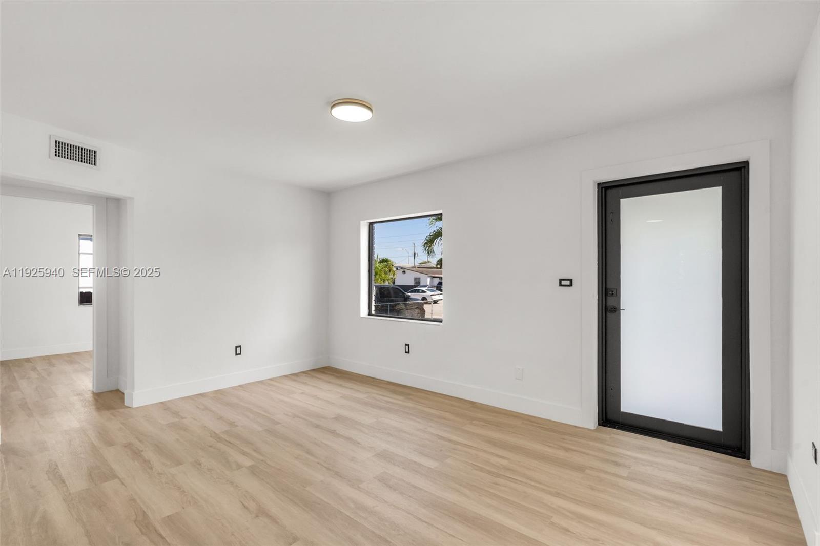 739 West 30th Street Hialeah, FL 33012 - Photo 4 of 23 a view of an empty room with wooden floor and closet