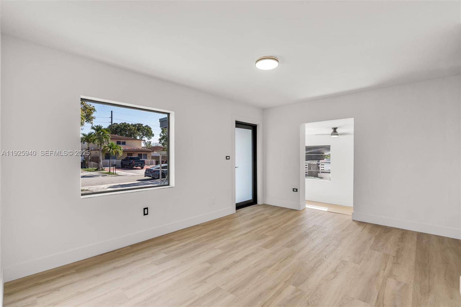 739 West 30th Street Hialeah, FL 33012 - Photo 5 of 23 a view of a big room with wooden floor and windows