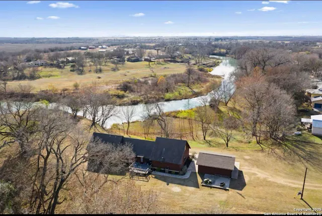 an aerial view of residential house with outdoor space and lake view