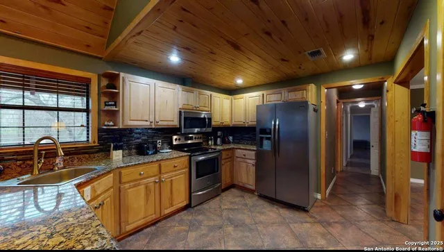 a kitchen with refrigerator a stove and cabinets