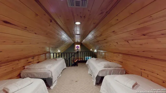 a view of a hallway with couches and large trees