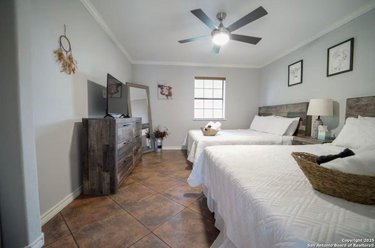 81 Butler Lane Martindale, TX 78655 - Photo 7 of 15 a bedroom with a bed and a flat screen tv