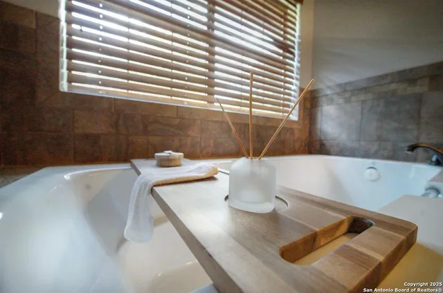 a bath tub sitting in a bathroom next to a window