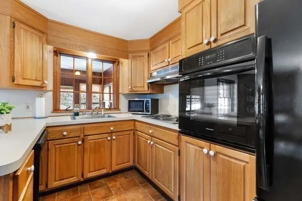 a kitchen with granite countertop a refrigerator and stove